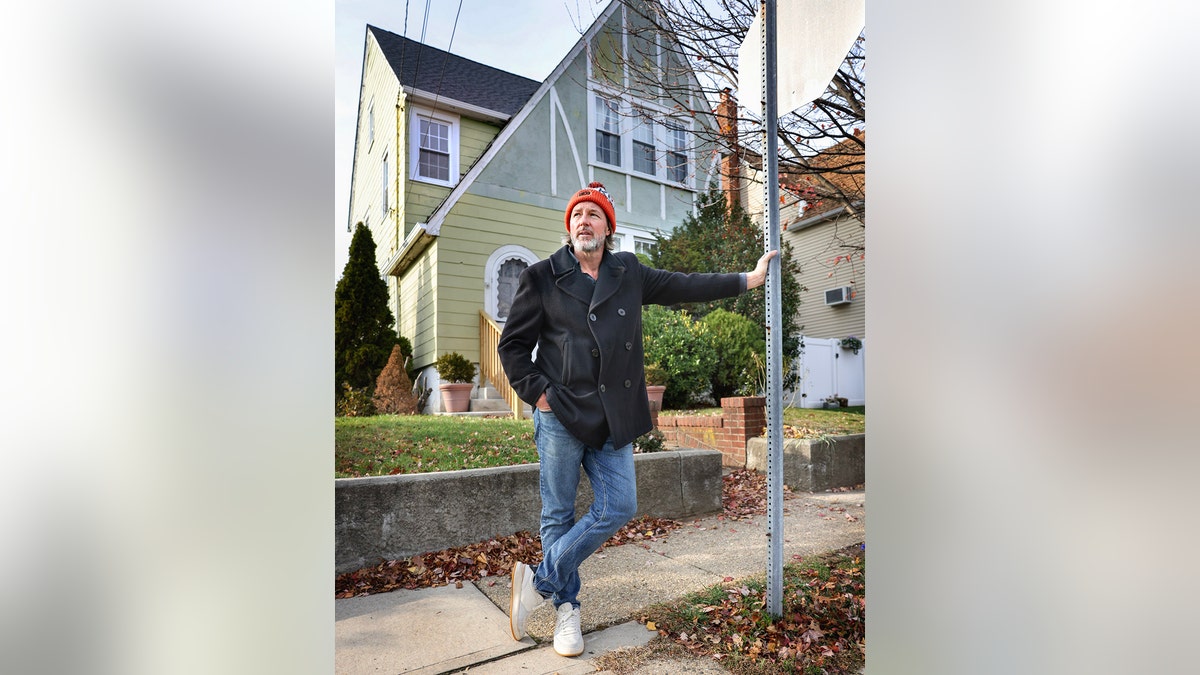Ed Burns standing in front of his childhood house.