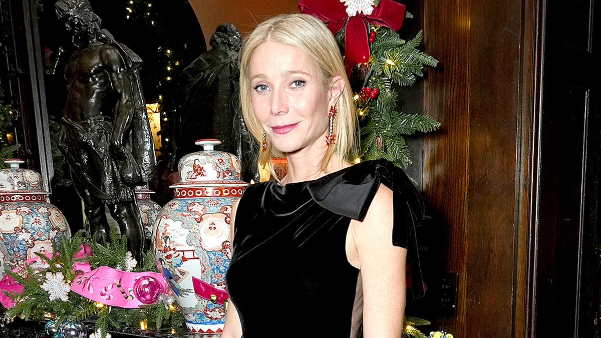 Gwyneth Paltrow poses for a photo in a black dress