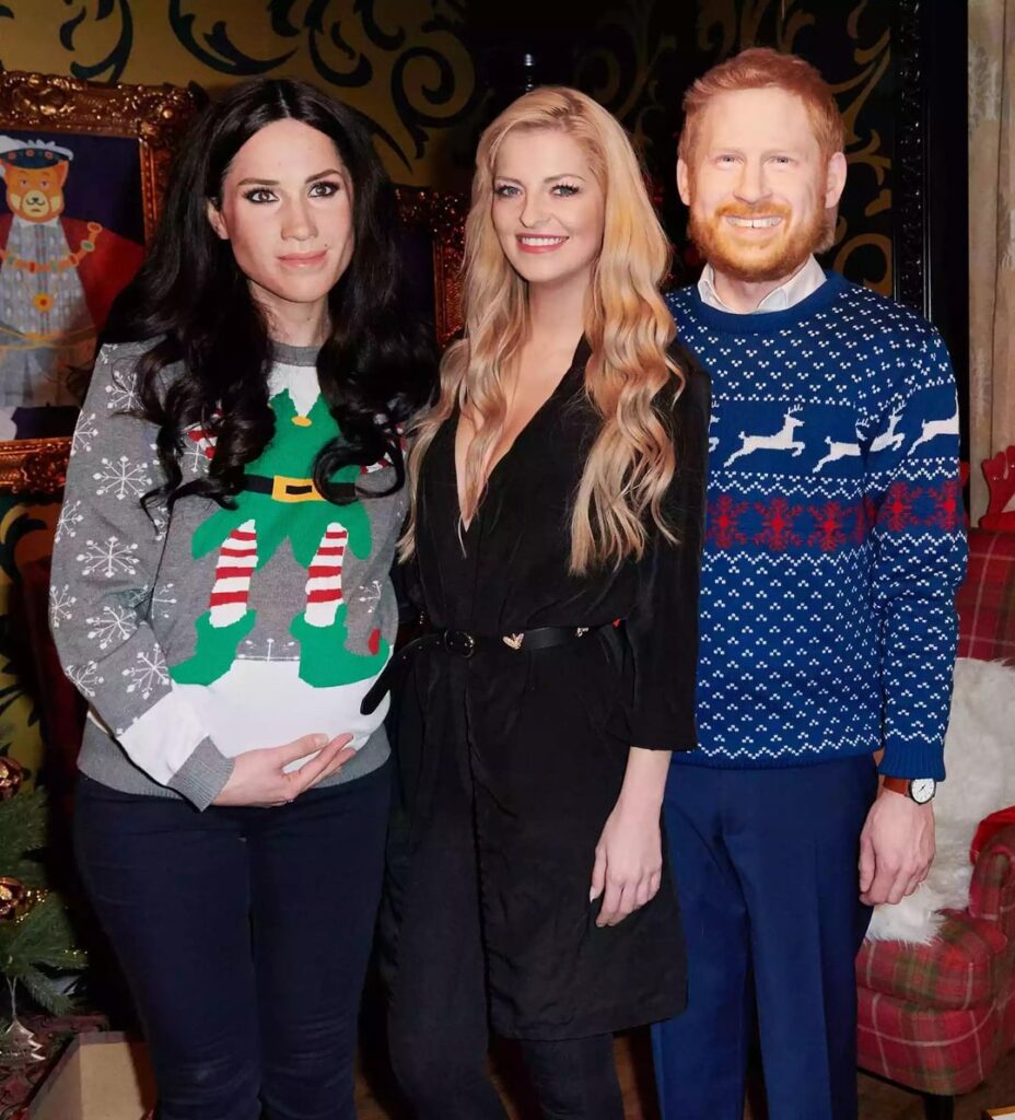 Throwback to that time Madame Tussaud’s Berlin paid actors to wear wax figure heads resembling Meghan and Harry at a holiday party, complete with ugly Christmas sweaters