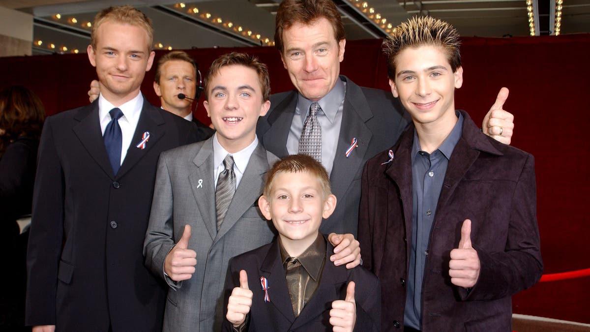 396787 23: The cast of "Malcolm In The Middle" give a thumbs up sign at the 53rd Annual Primetime Emmy Awards at the Shubert Theater November 4, 2001 in Los Angeles, CA. (L-R) Actors Christopher Masterson, Frankie Muniz, Erik Per Sullivan (front center), Bryan Cranston and Justin Berfield. (Photo by 