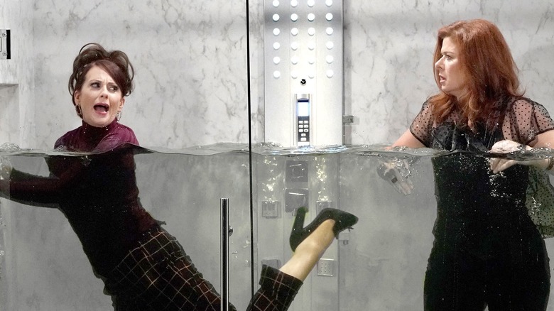 Karen and Grace in an elevator submerged in water on Will & Grace