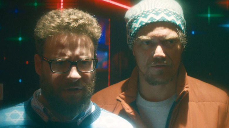 Isaac and Mr. Green in a dream state strip club in The Night Before