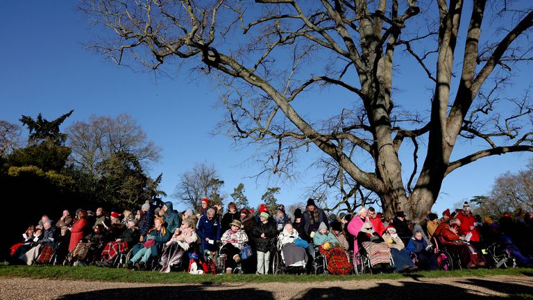 People wait outside as the Royal Family attend the Christmas Day service. Pic: Reuters 