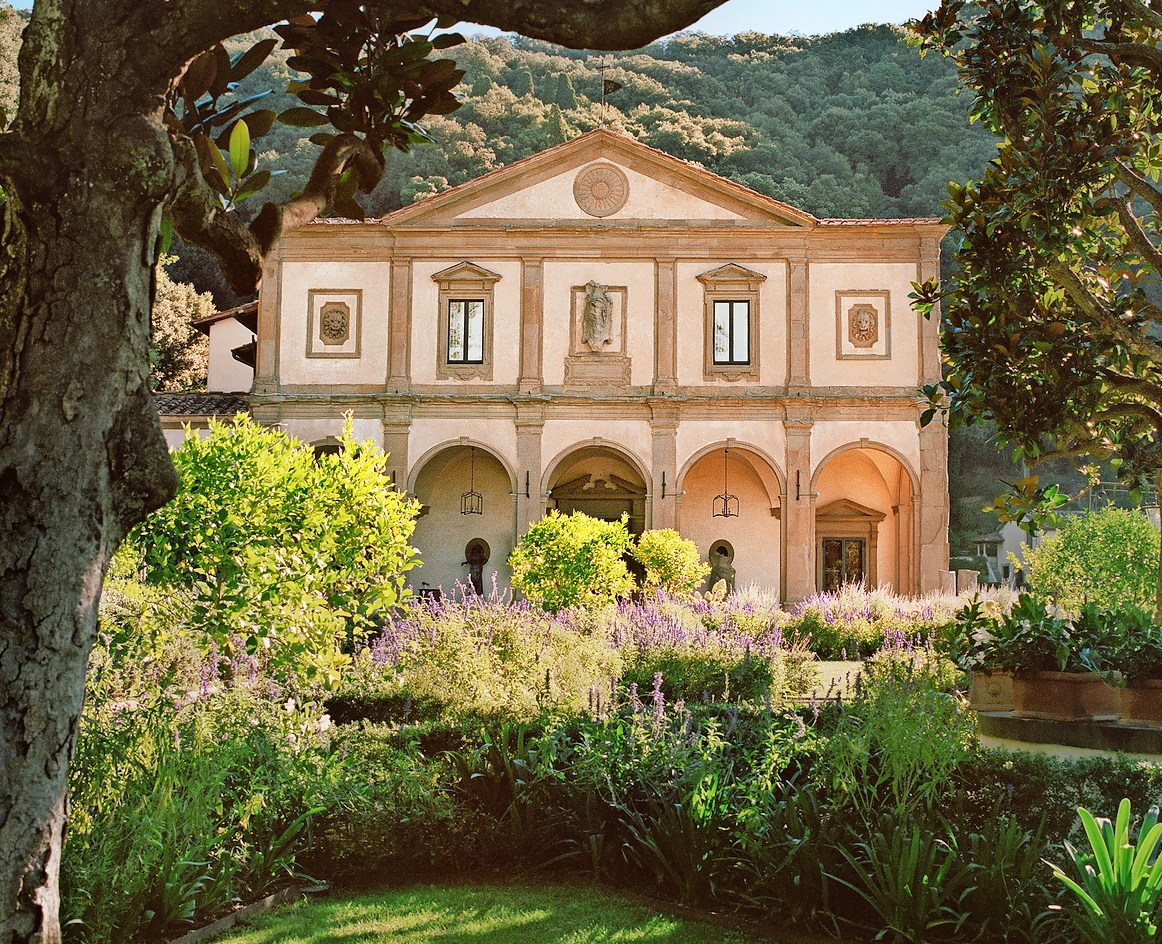 Villa San Michele, A Belmond Hotel, Italy, framed by trees and a garden.