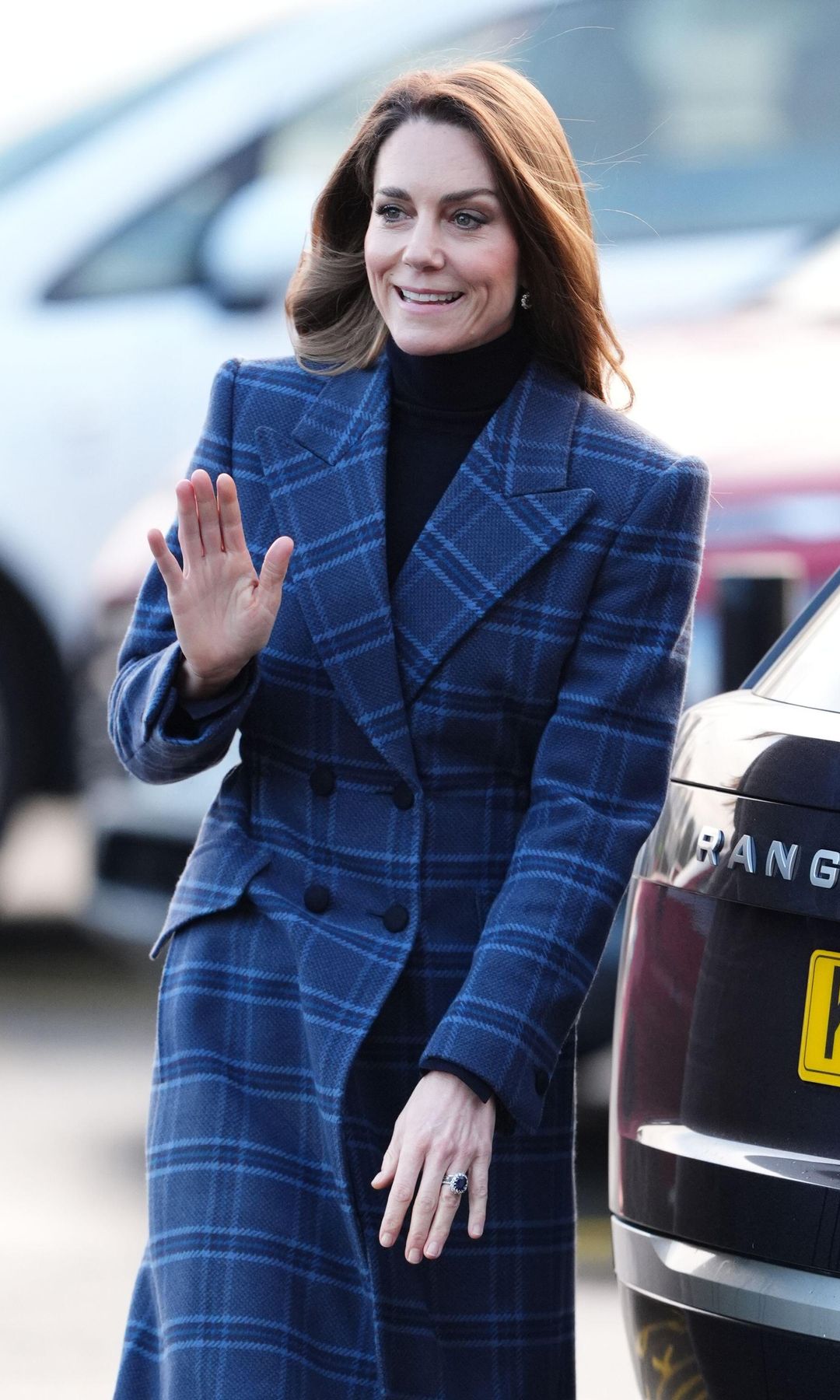 Kate Middleton walking in a tartan overcoat