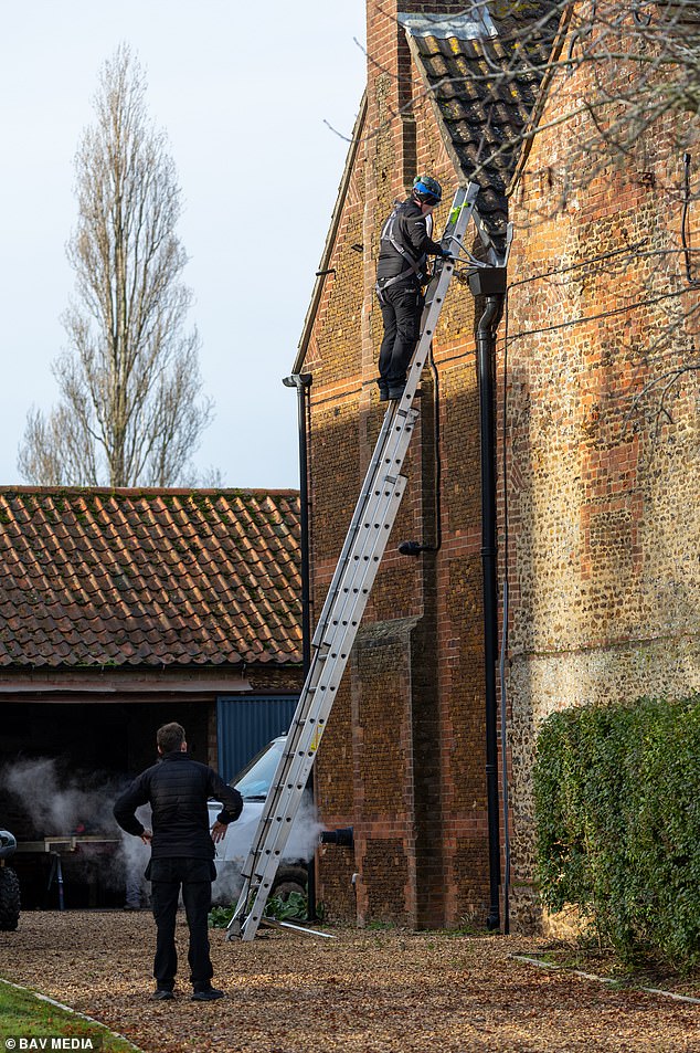 A Sky engineer up a ladder against the wall of Marsh Farm where Andrew is expected to move. The former Duke of York is said to enjoy watching the golf on TV