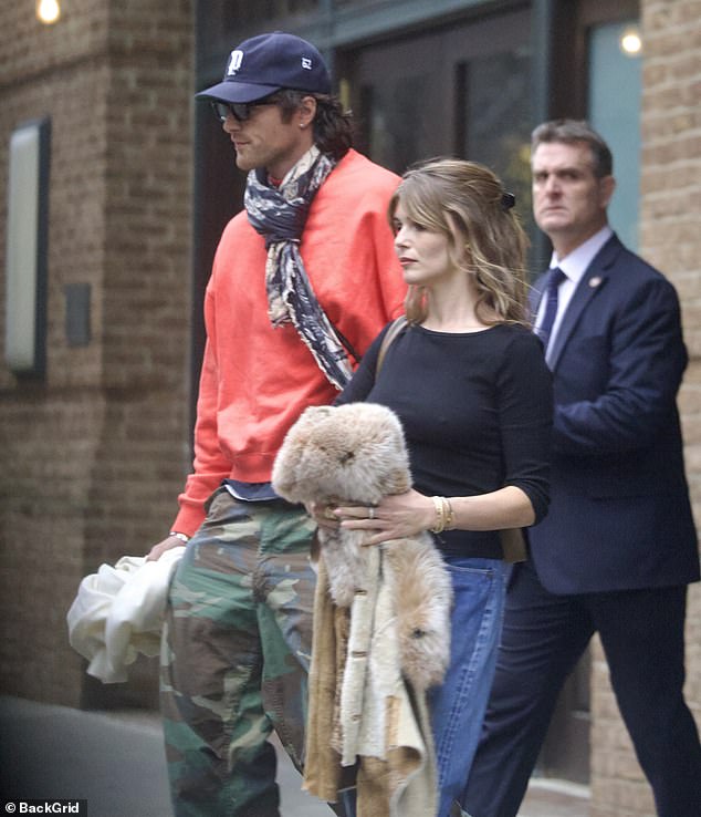 The hunky Euphoria actor sported a bright orange sweatshirt and cammo pants as he left the hotel accompanied by Jade