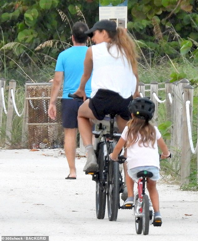 Dressed in a white top, black athletic shorts and a baseball cap, the beauty showcased her toned physique while keeping the look casual and practical for the family excursion