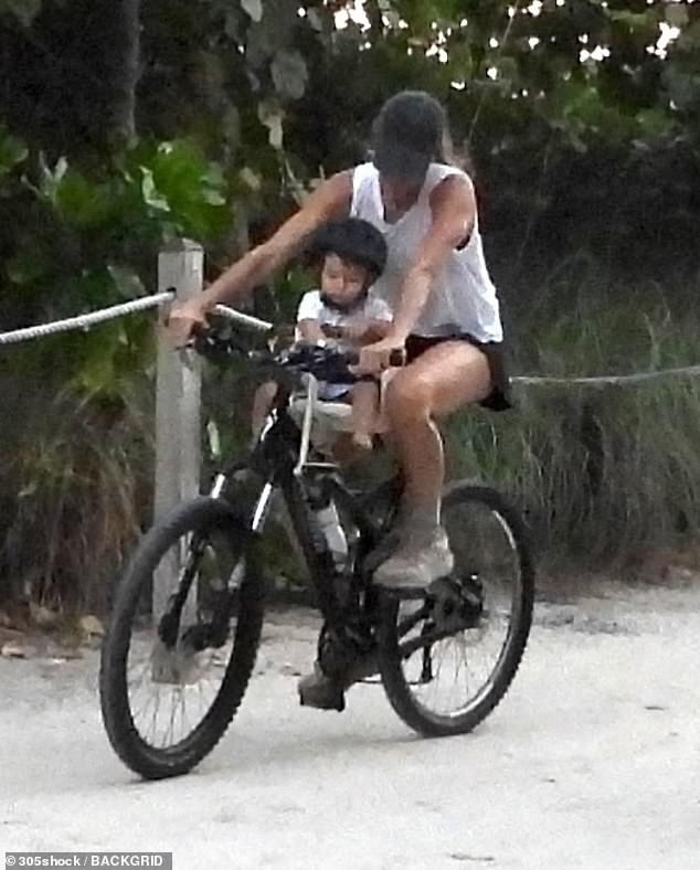 The supermodel looked relaxed as she pedaled along a scenic path, safely guiding her baby boy, whom she shares with husband Joaquim Valente, during the outdoor outing