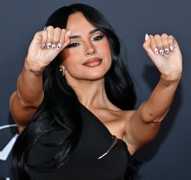 Singer Becky G paints her nails with ‘Fuck ICE’ to protest against the agency.