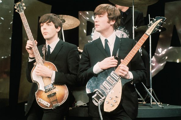 British Rock musicians Paul McCartney (left) and John Lennon (1940 - 1980), of the group the Beatles, perform on the set of