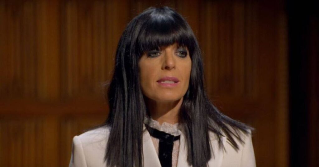 ‘I went to uni with Claudia Winkleman and one thing she says about herself isn’t true’ An individual with a beard, donning a green hooded cloak, stands in a dimly lit room with an intricate background.