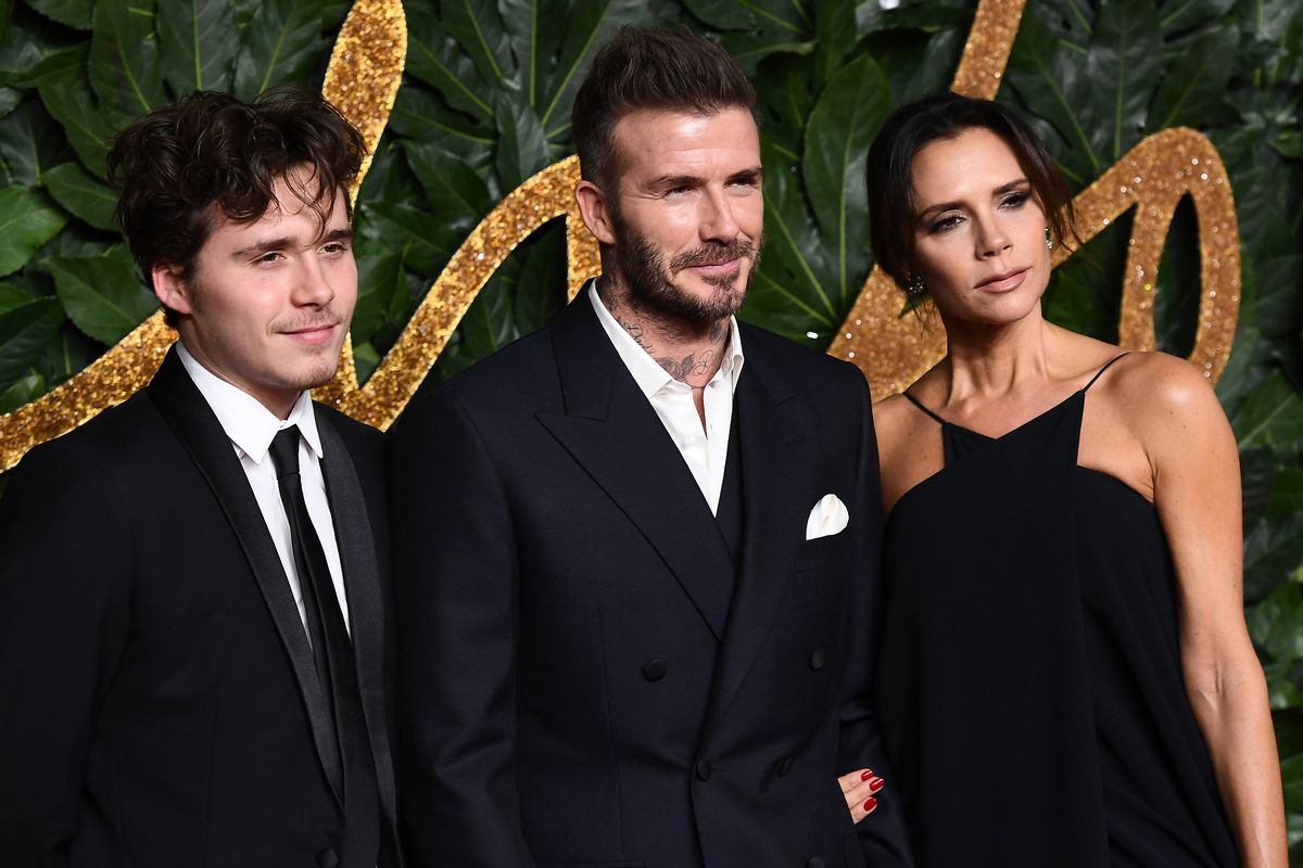 Brooklyn Beckham, David Beckham and Victoria Beckham all arrive at a fashion show.