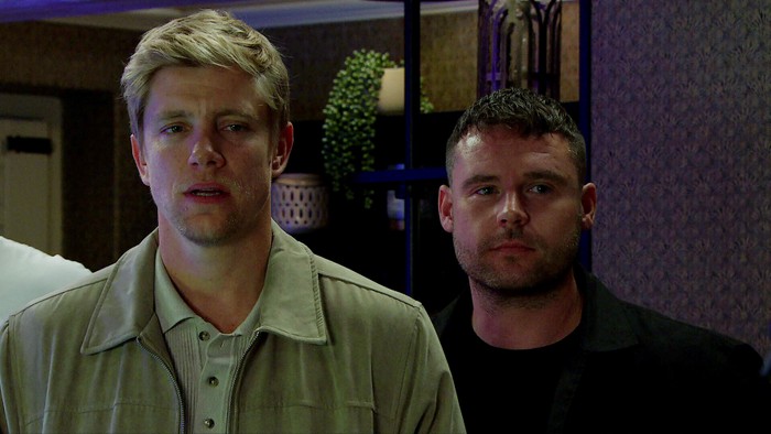 Robert and Aaron look shocked in Emmerdale.
