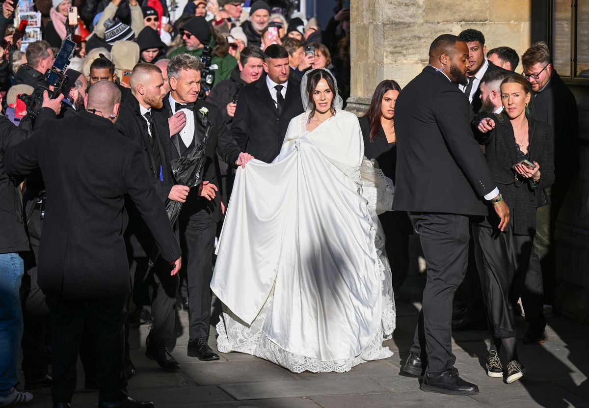Holly's dress was kept covered with a bridal cape