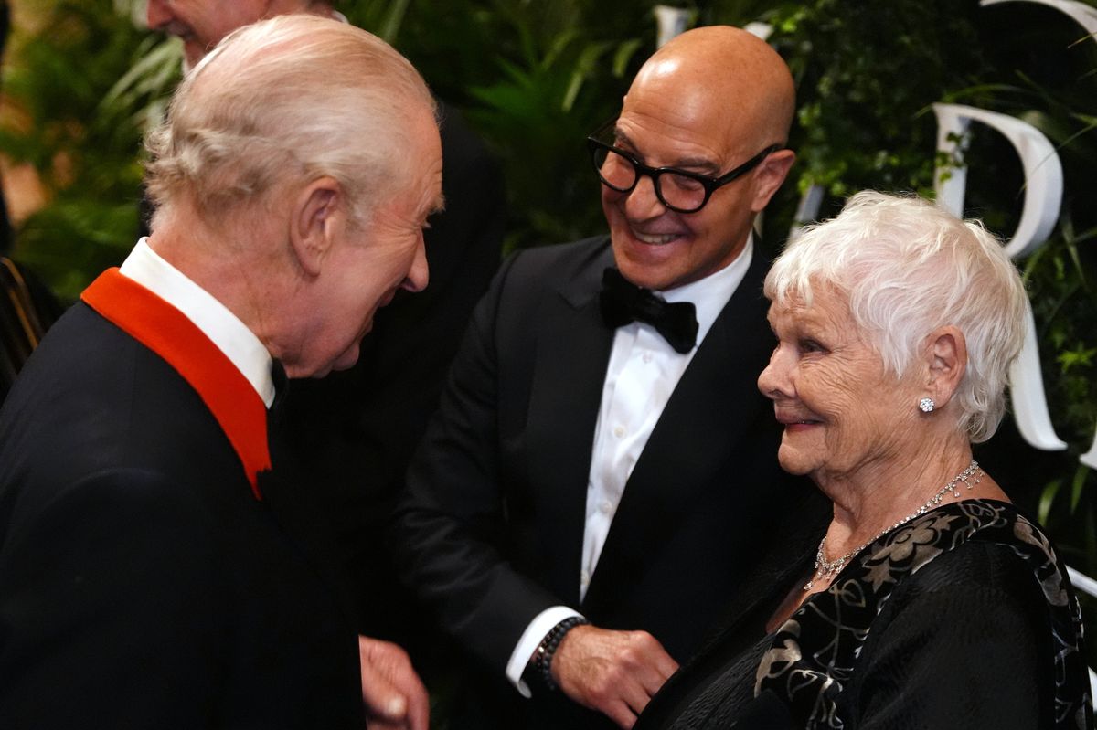 King Charles III speaking to Stanley Tucci and Dame Judi Dench at Windsor Castle
