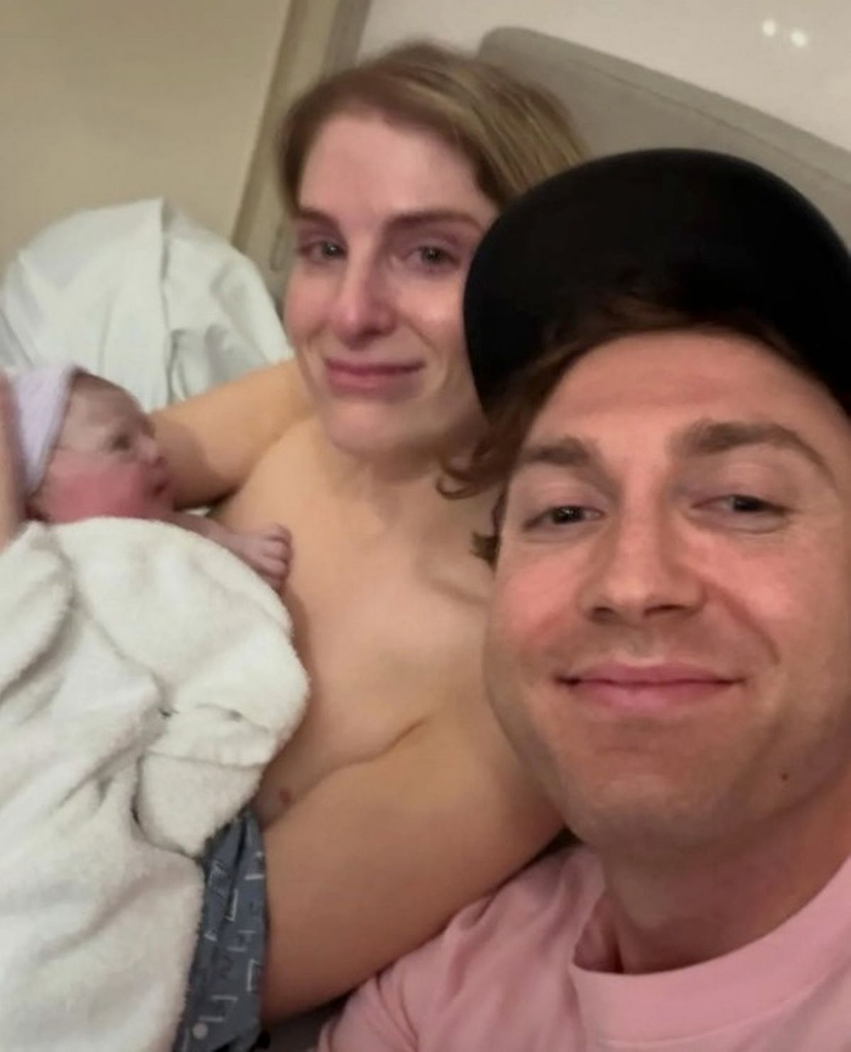 Meghan, holding her baby, is pictured with husband Daryl Sabara
