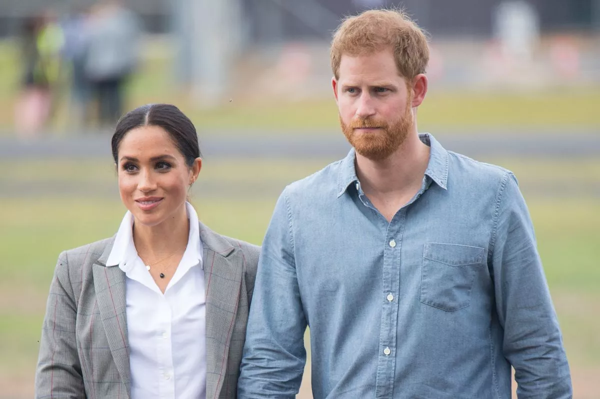 Prince Harry and Meghan Markle in casual clothing at an event in Australia