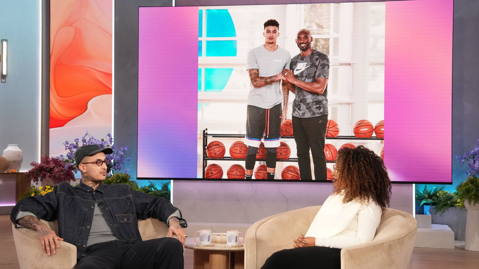 Image may contain Kobe Bryant Clothing TShirt Shorts People Person Face Head Photography Portrait and Couch