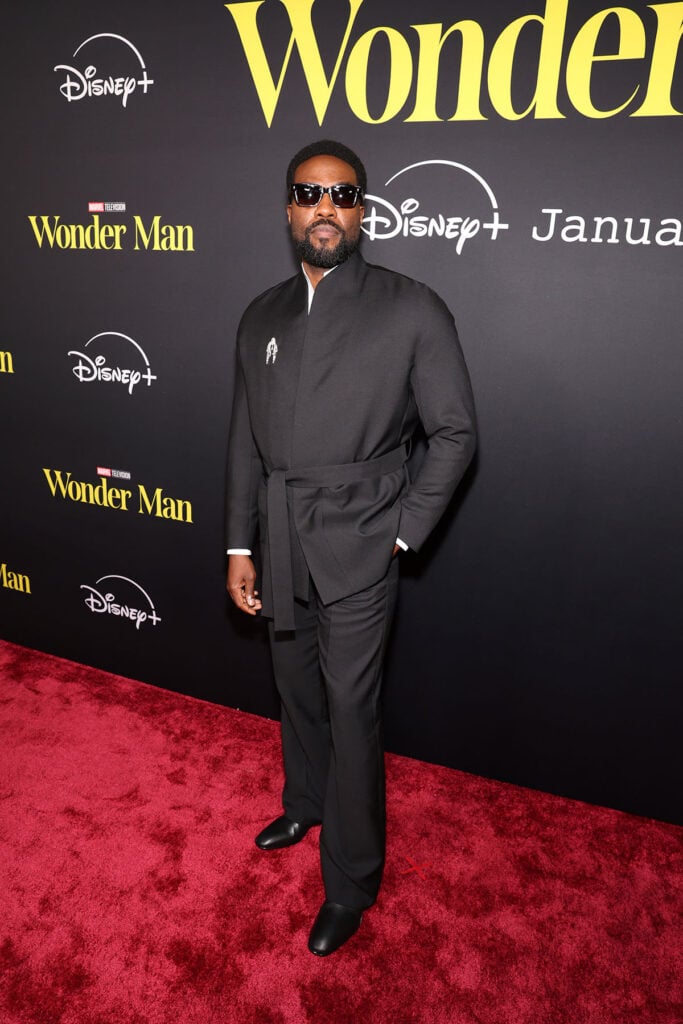 Yahya Abdul-Mateen II attends the Wonder Man launch event, Yahya Abdul Mateen II, Yahya Abdul Mateen II Wonder Man premiere, Yahya Abdul Mateen II Zegna, Zegna wrap jacket, Briony Raymond brooch, Christian Louboutin boots, Wonder Man launch event red carpet, Yahya Abdul Mateen II style