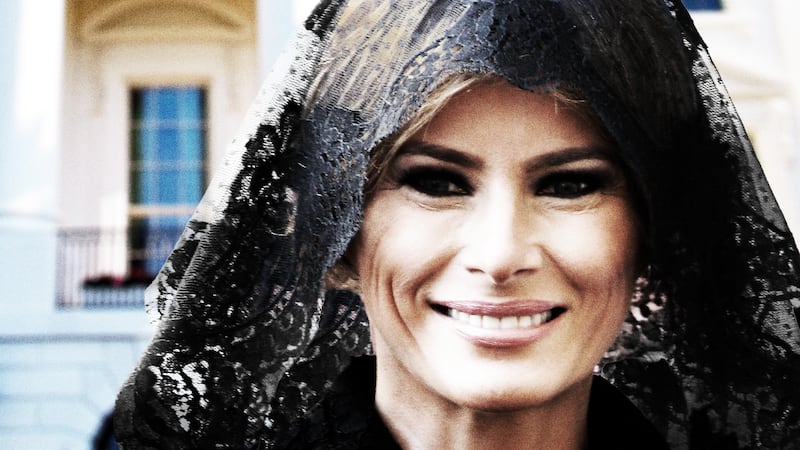 Melania smiling in funeral attire.