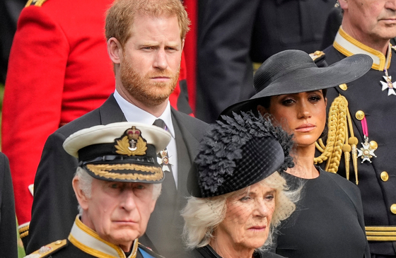 Britain's King Charles III, from bottom left, Camilla, the Queen Consort, Prince Harry and Meghan, Duchess of Sussex watch as the coffin of Queen Elizabeth II is placed into the hearse following the state funeral service in Westminster Abbey in central London Monday Sept. 19, 2022. [AP/YONHAP]