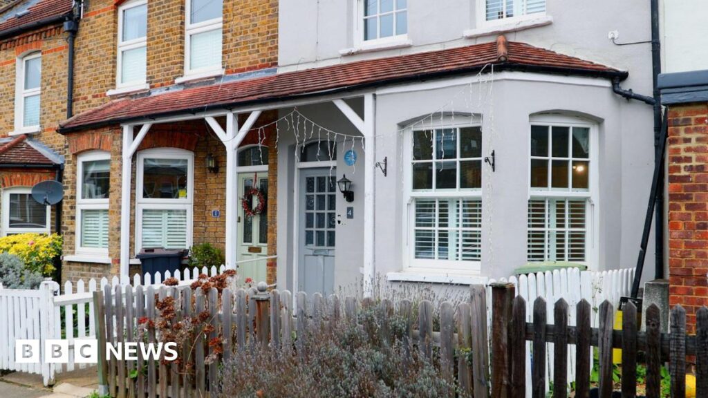 David Bowie’s London childhood home set to open to the public A row of terraced houses with brick and painted facades, white-framed windows, small front gardens, and low wooden fences along a residential street.