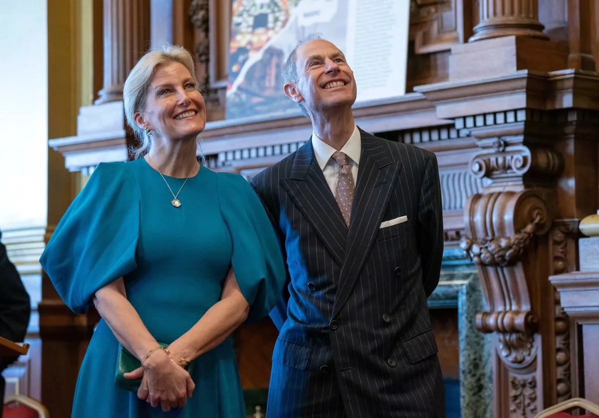 Prince Edward, Duke of Edinburgh and Sophie, Duchess of Edinburgh standing together and wearing formal outfits
