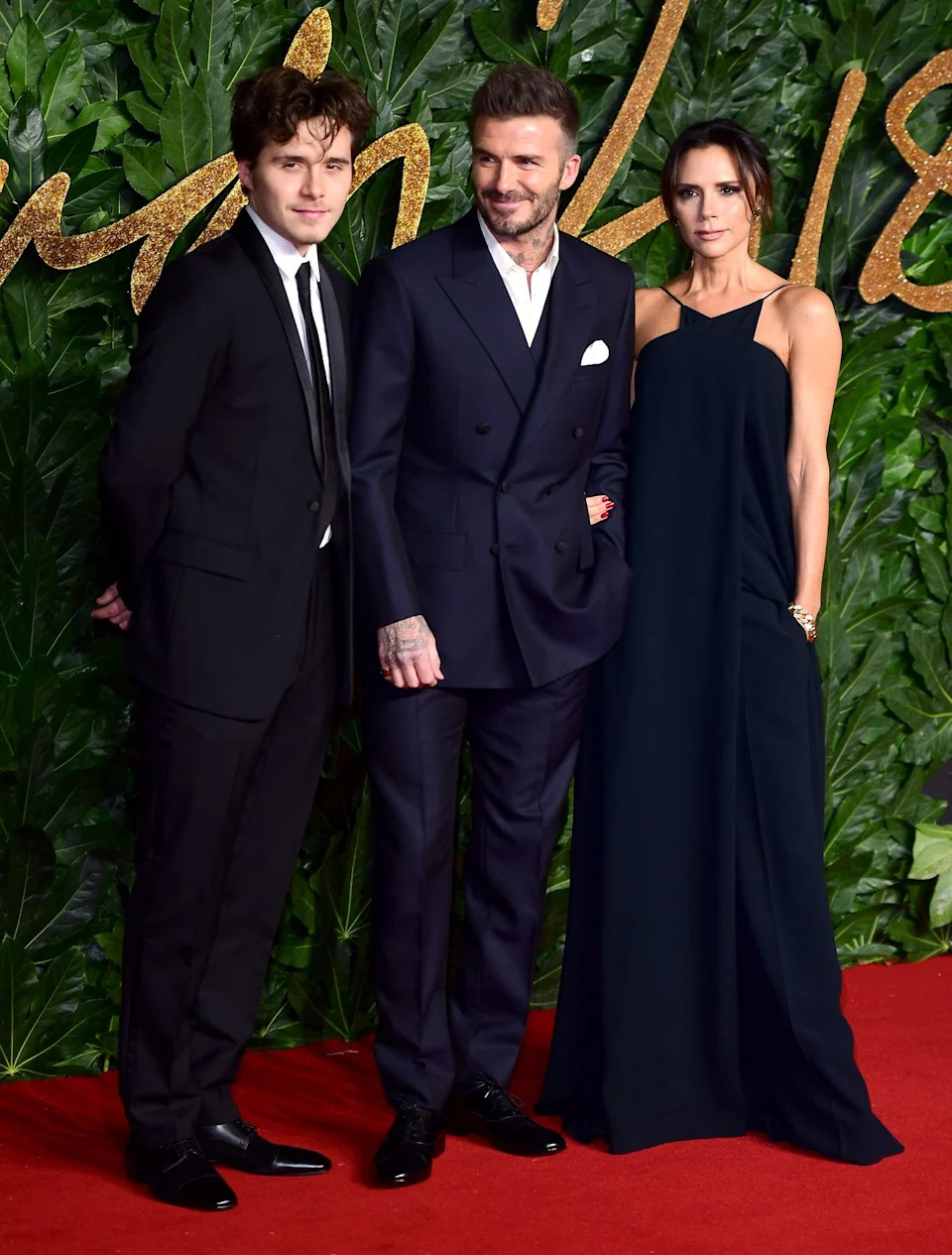 Brooklyn, David and Victoria Beckham pictured together before the public fallout (PA Archive)