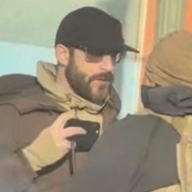 Alex Pretti holding his phone in front of an ICE agent