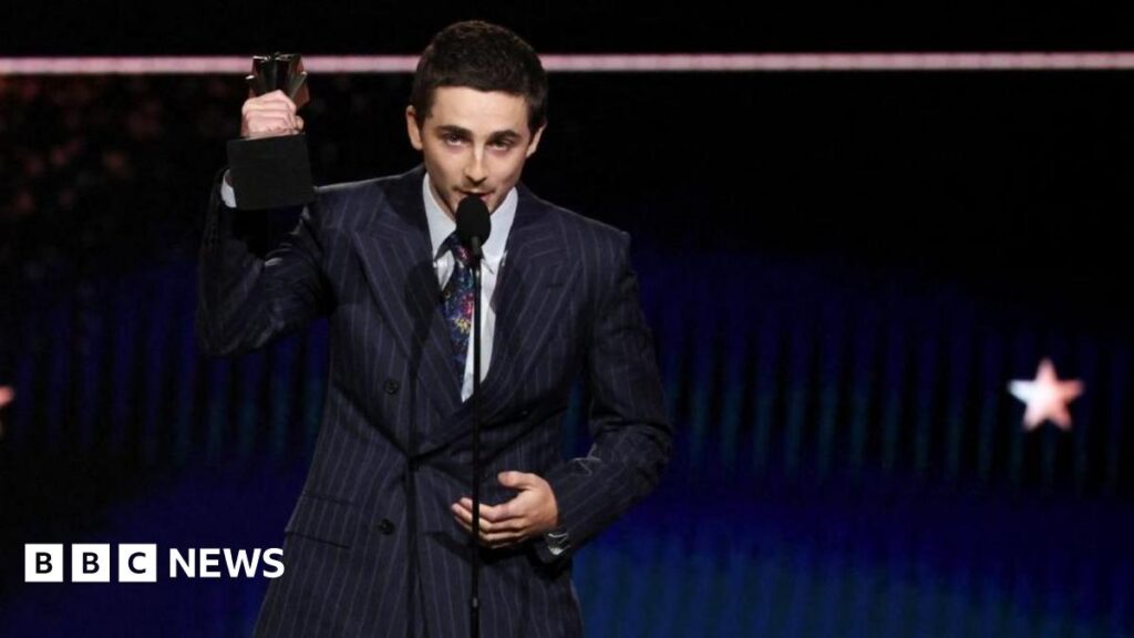 Owen Cooper tells Timothée Chalamet ‘I’m not Scouse’ at awards Timothée Chalamet, who is wearing a pin-striped suit, white shirt and patterned tie, accepts the Best Actor Award for Marty Supreme at the 31st Annual Critics Choice Awards in Santa Monica, California. He is holding his award in the air as he talks into a microphone.