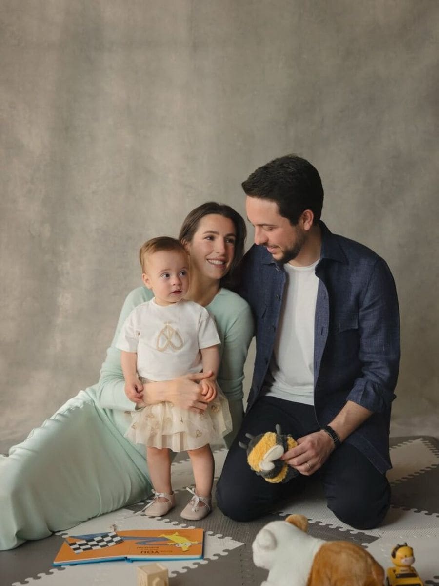 Crown Prince Hussein, Princess Rajwa, and Baby Iman pose for a New Year family portrait.