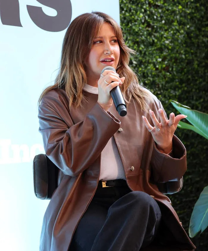 Ashley speaking into a microphone