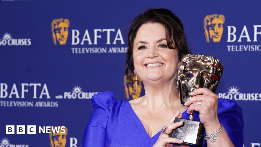 Ruth Jones excited by first dramatic role in Netflix series Run Away Ruth Jones holds up a BAFTA Award in the shape of a theatre mask, with a purple background behind her. She's wearing a blue dress with mid-length sleeves, with her dark hair tied up.