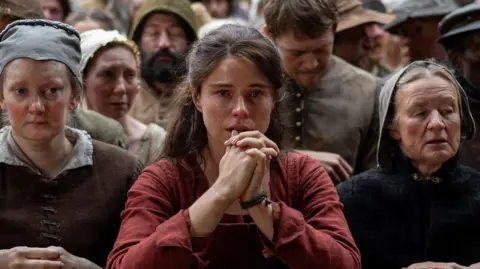 Agata Grzybowska/Focus Features Jessie Buckley's Agnes pressed up against the front of the stage at The Globe Theatre