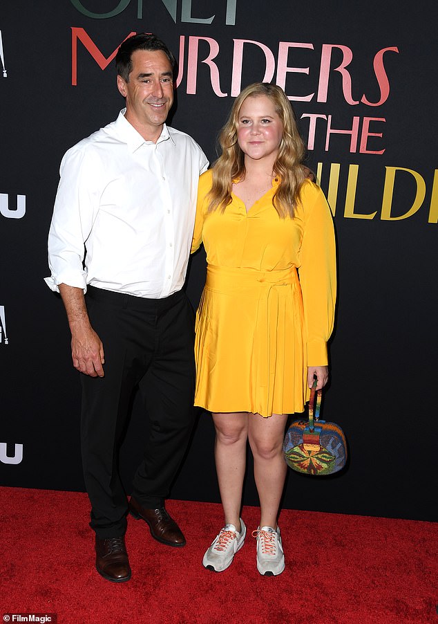 The comedian welcomed her first child with husband Chris Fischer on May 5 2019 and named him Gene Attell Fischer, the middle name chosen in honor of her close friend and fellow comic Dave Attell (pictured with Chris in 2022)