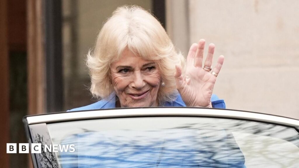 Queen Camilla waves to public as she enters a car