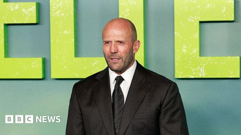 Jason Statham: I’ve taken a lot of stunts too far Donald Trump and Keir Starmer sit in a formal drawing room setting on arm chairs with US and UK flags behind them. Both have serious expressions and are looking out and not at each other.