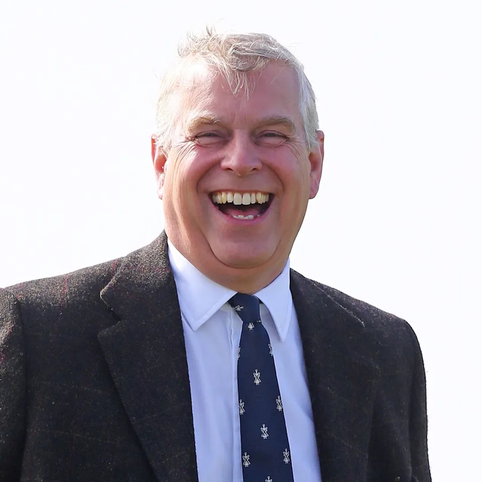  Ex-Prince Andrew laughs while wearing a suit and tie. 