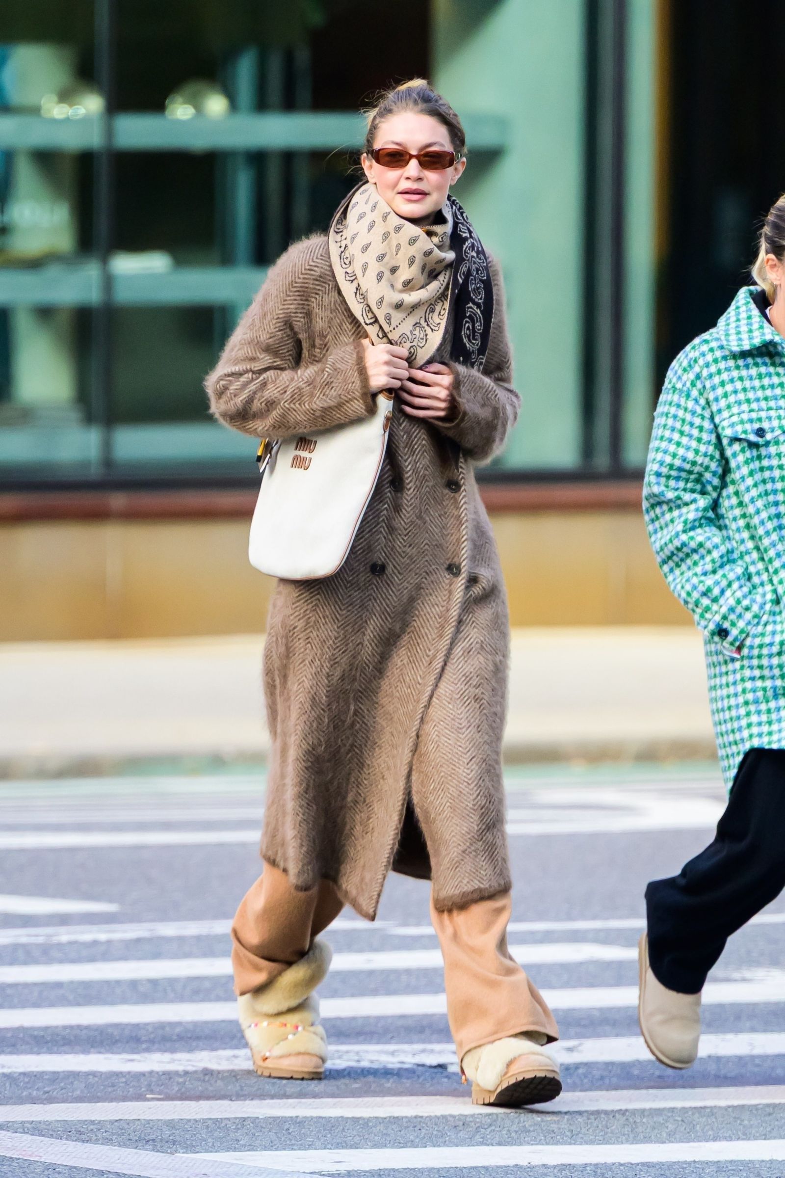 Image may contain Gigi Hadid Pedestrian Person Clothing Coat Scarf Overcoat Accessories Bag Handbag and Adult