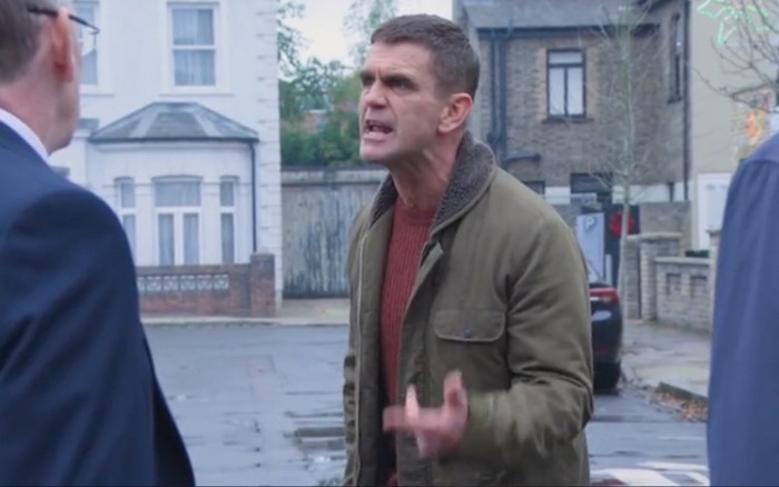 Scott Maslen as an angry and animated Jack Branning speaking to Adam Woodyatt as Ian Beale on the street in EastEnders.