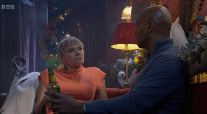 Nicola and George sat in the Vic in EastEnders.