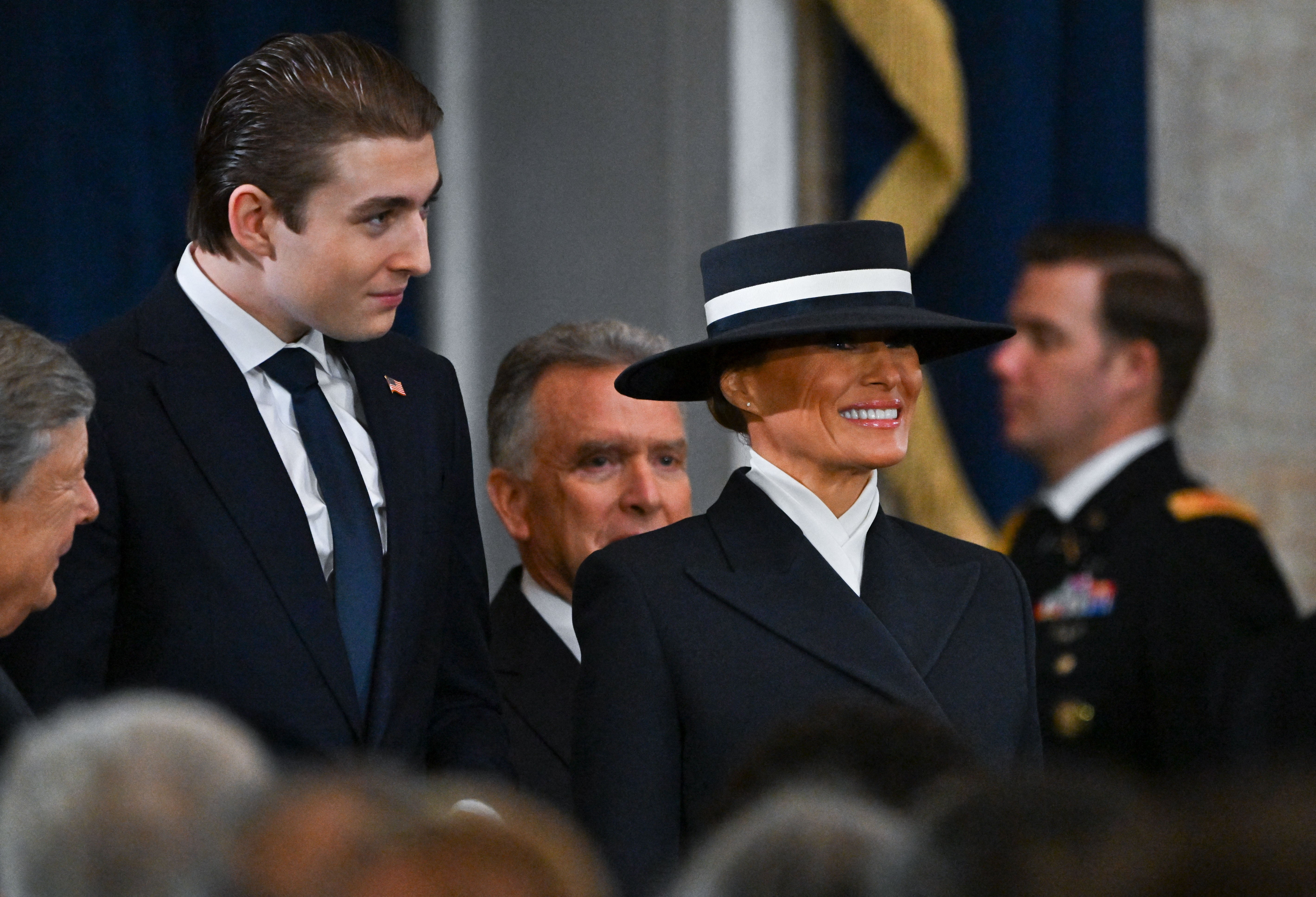 While much has been made in the film of the first lady’s inauguration day “Hamburglar” hat (left); the golden eggs filled with caviar guests were served at a banquet on the eve of the ceremony; and several mentions of how tall Barron is, the so-called documentary also serves as a vehicle to promote the MAGA-Trump agenda