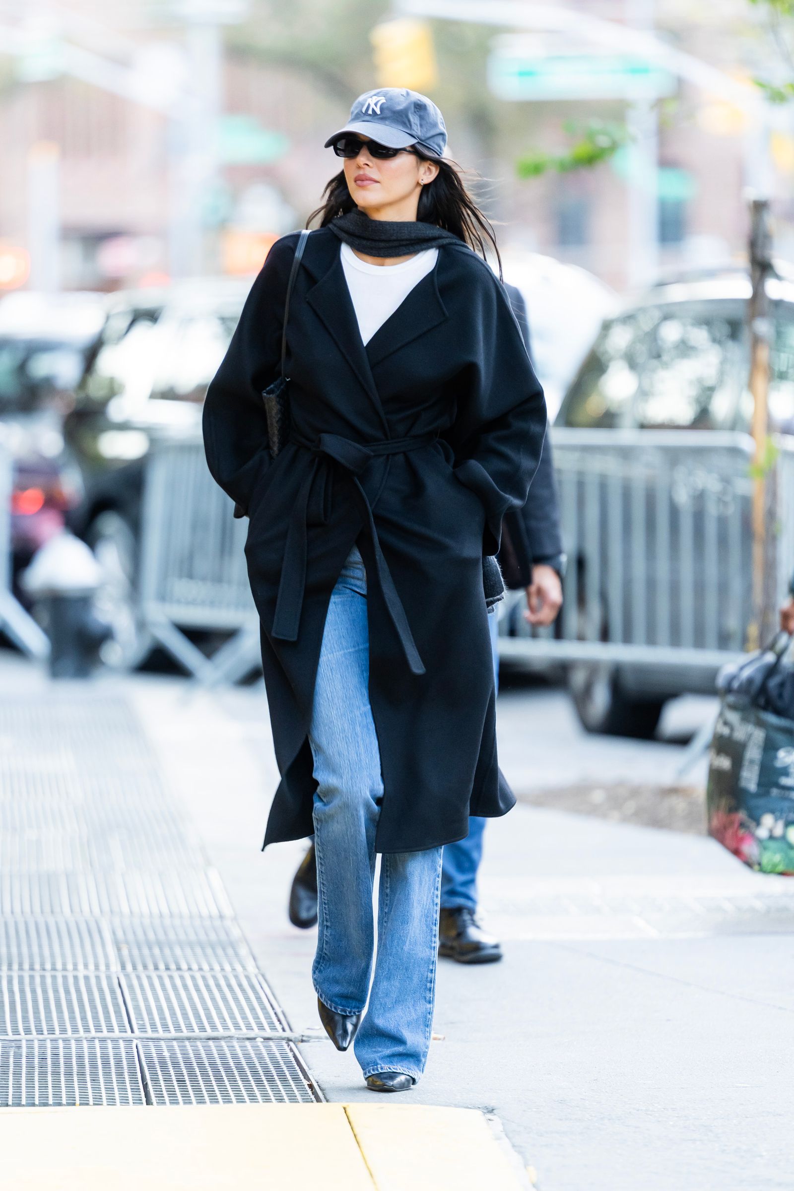 Image may contain Kendall Jenner Clothing Coat Pants Overcoat Jeans Baseball Cap Cap Hat Accessories and Bag