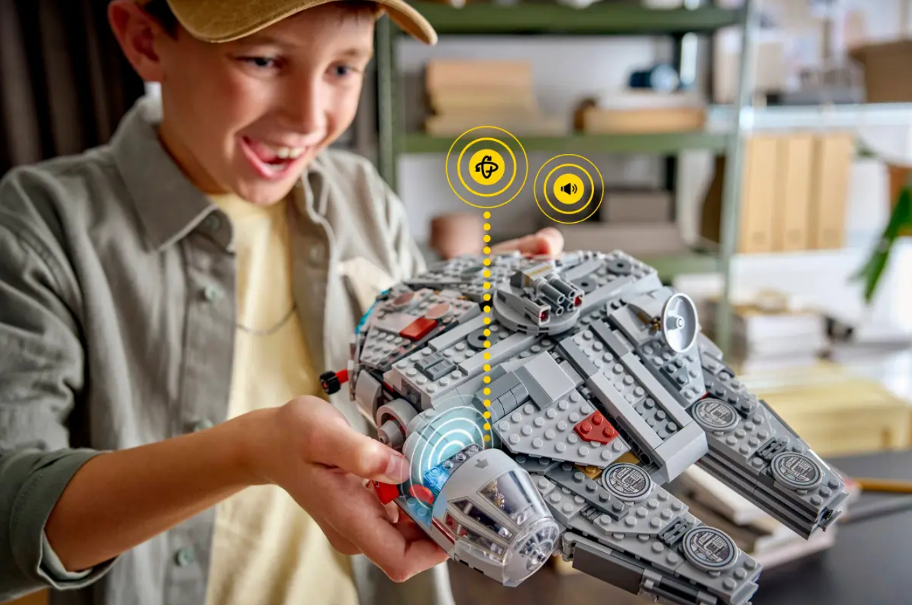A child plays with a LEGO Millennium Falcon
