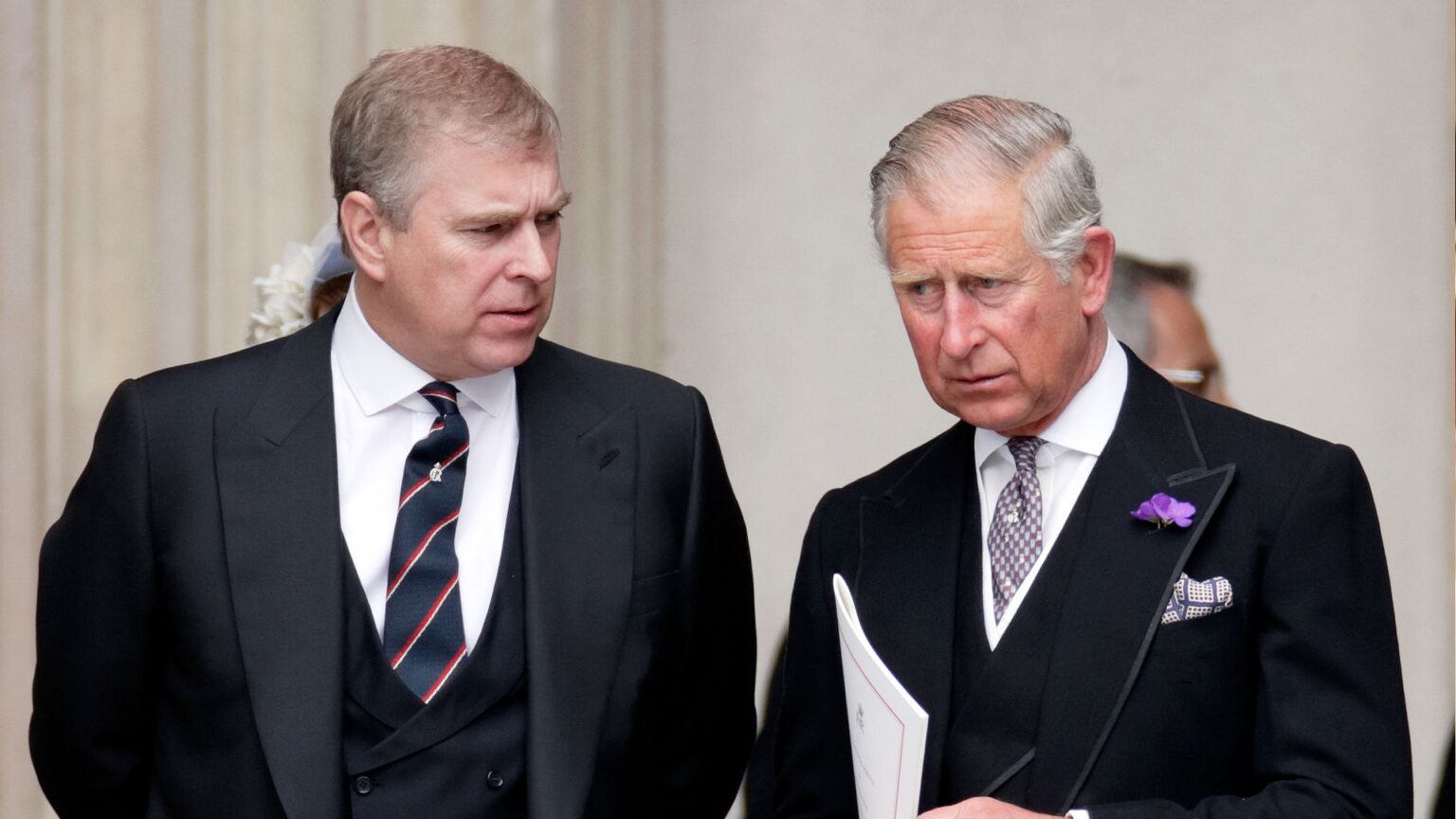One Royal Is “Vocal” About King’s “Harsh” Treatment of Andrew King Charles and Prince Andrew wearing dark suits, ties and serious expressions