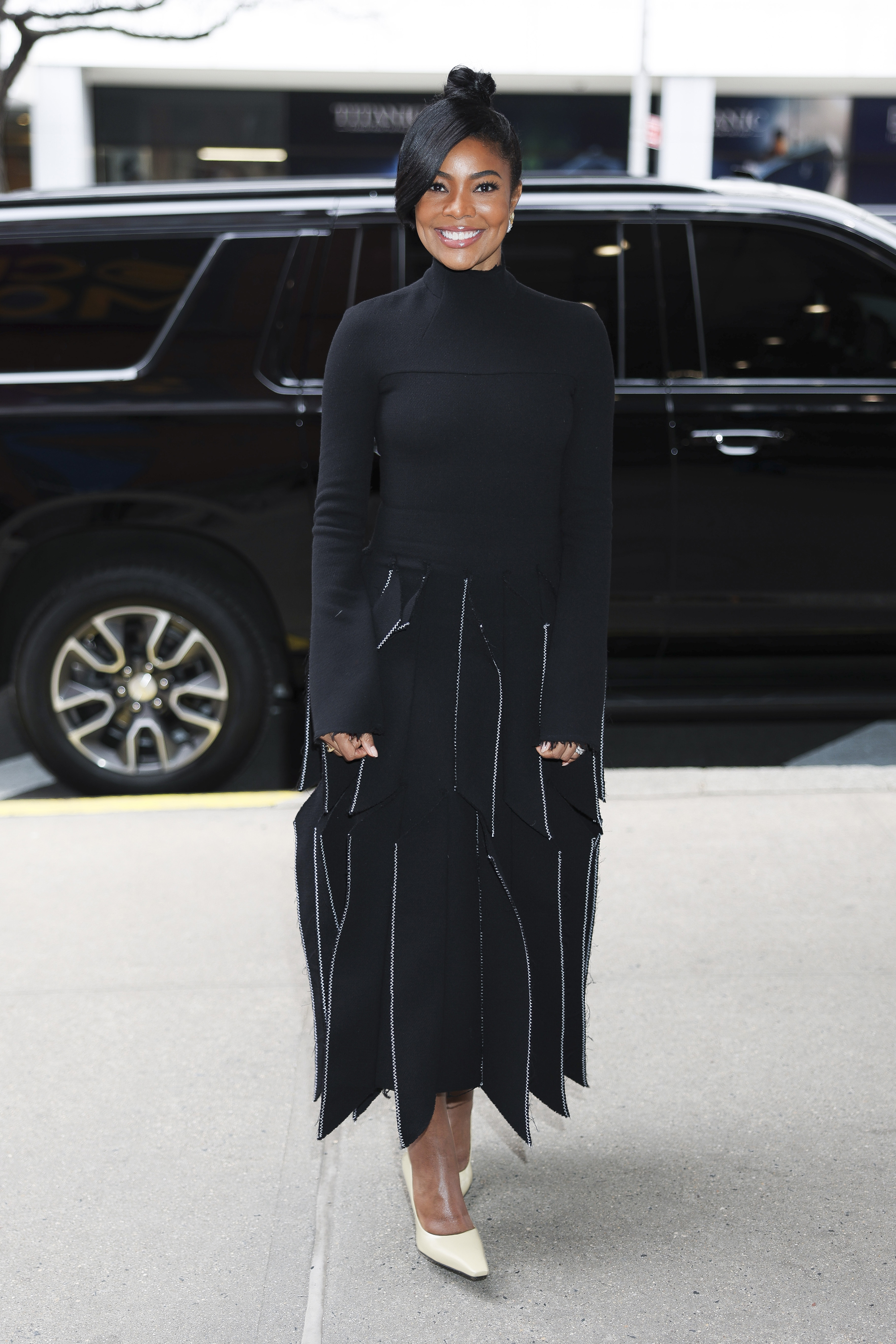 Gabrielle Union in new york city wearing a black turtleneck dress from a.w.a.k.e.mode