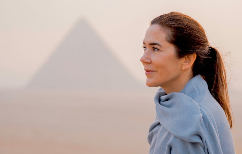 Queen Mary with the Great Pyramid at Giza, Egypt behind her