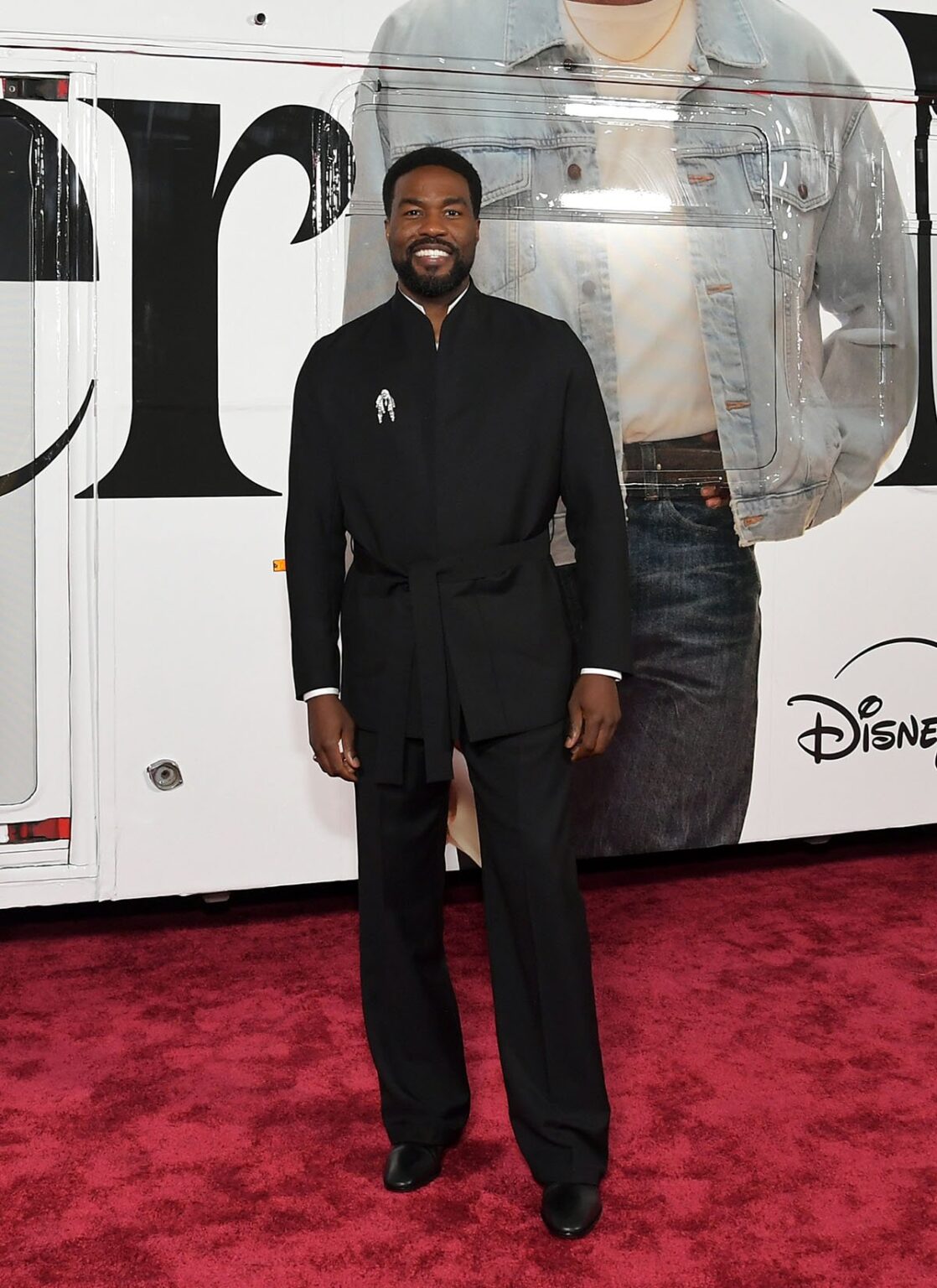Yahya Abdul-Mateen II attends the Wonder Man launch event, Yahya Abdul Mateen II, Yahya Abdul Mateen II Wonder Man premiere, Yahya Abdul Mateen II Zegna, Zegna wrap jacket, Briony Raymond brooch, Christian Louboutin boots, Wonder Man launch event red carpet, Yahya Abdul Mateen II style