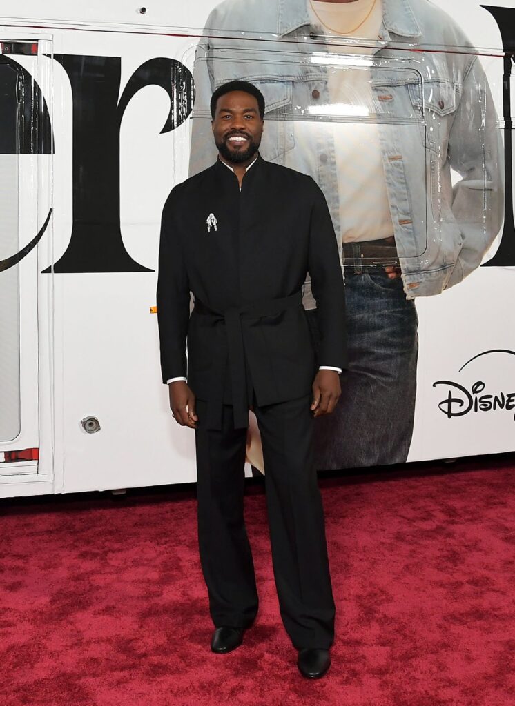 Yahya Abdul-Mateen II attends the Wonder Man launch event, Yahya Abdul Mateen II, Yahya Abdul Mateen II Wonder Man premiere, Yahya Abdul Mateen II Zegna, Zegna wrap jacket, Briony Raymond brooch, Christian Louboutin boots, Wonder Man launch event red carpet, Yahya Abdul Mateen II style